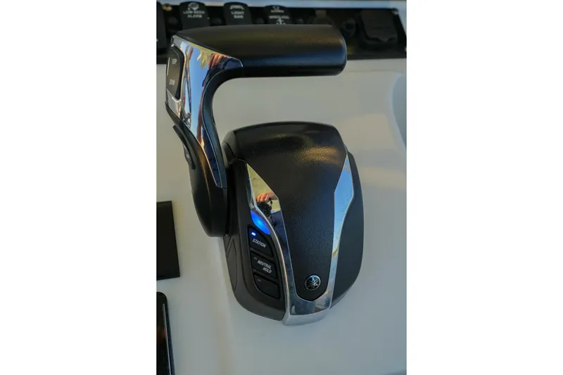 Slide: The Image of Throttle control of 2022 Sea Hunt Ultra 229 boat, featuring sleek design and control buttons. - 8
