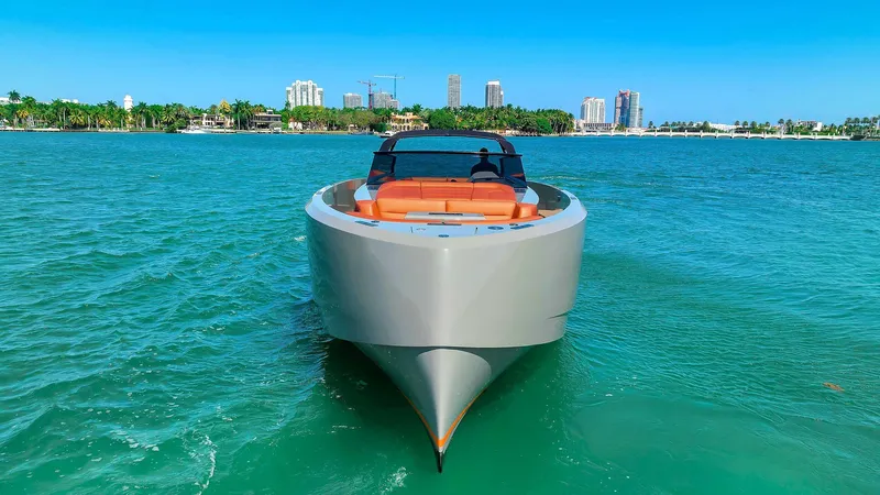 Slide: The Image of 2021 Vanquish Yachts VQ 45 on turquoise water with city skyline. - 10