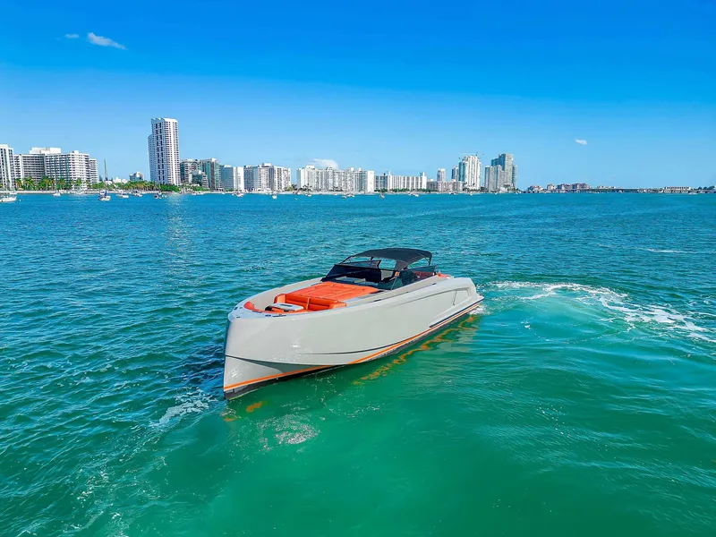 Slide: The Image of Vanquish Yachts VQ 45, 2021 model, cruising in a vibrant coastal cityscape. - 3