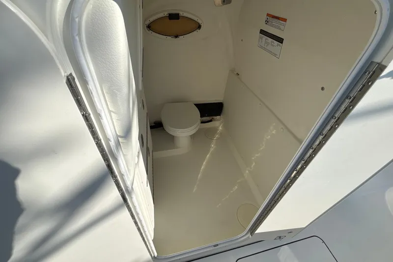 Slide: The Image of Interior view of 2026 World Cat 325 CC boat's compact bathroom space. - 10