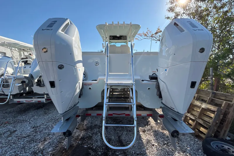 Slide: The Image of 2026 World Cat 325 CC boat with dual outboard engines, rear view. - 3