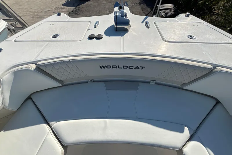 Slide: The Image of 2026 World Cat 325 CC boat interior with cushioned seating and storage compartments. - 7