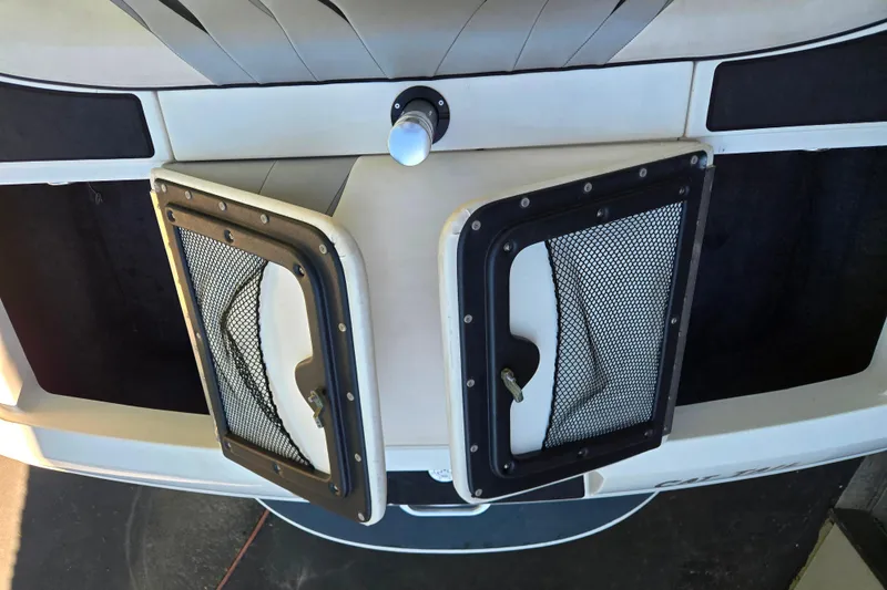 Slide: The Image of 2010 MB SPORTS 21 Tomcat boat with open storage compartments and mesh covers. - 14