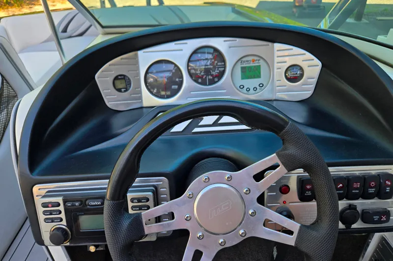 Slide: The Image of Dashboard of a 2010 MB SPORTS 21 Tomcat boat with steering wheel and gauges. - 20