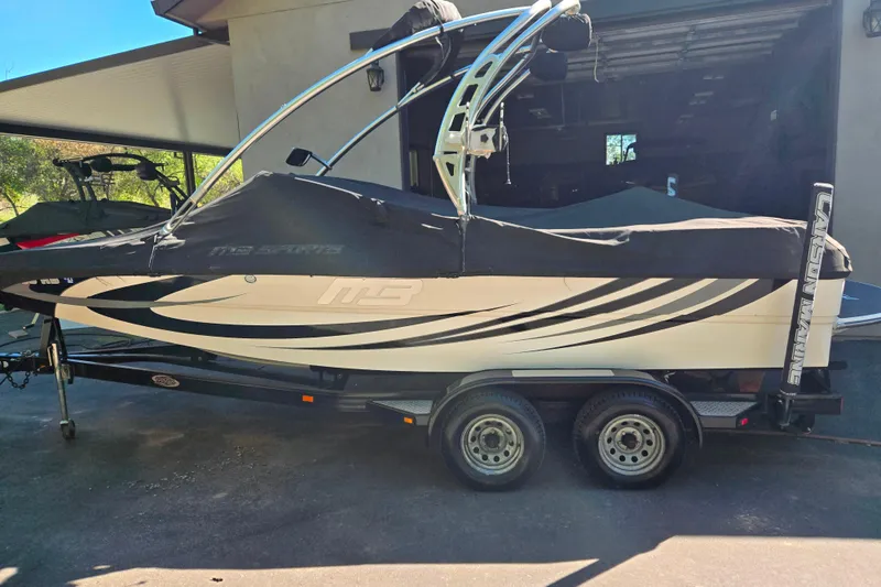 Slide: The Image of 2010 MB SPORTS 21 Tomcat boat on trailer, covered and parked in driveway. - 22