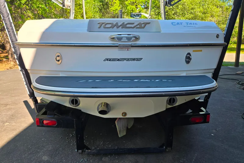 Slide: The Image of Rear view of 2010 MB SPORTS 21 Tomcat boat, showcasing sleek design and branding. - 3
