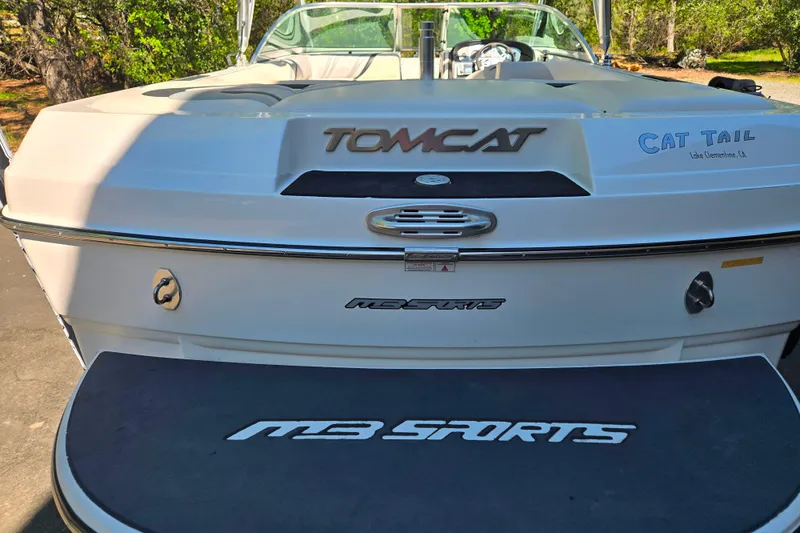 Slide: The Image of 2010 MB SPORTS 21 Tomcat boat rear view with branding and swim platform. - 4