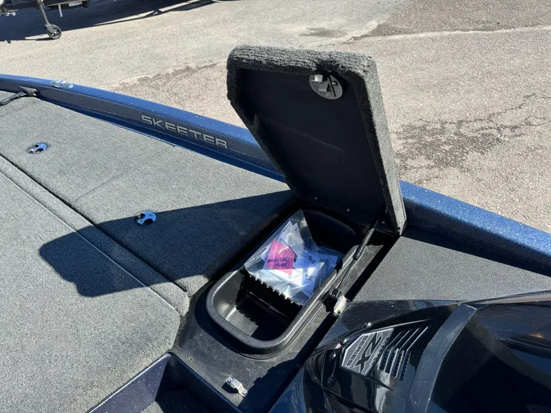 Slide: The Image of 2019 Skeeter ZX225 boat with open storage compartment on deck. - 16