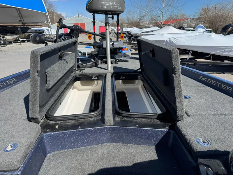 Slide: The Image of 2019 Skeeter ZX225 boat with open storage compartments outdoors. - 18