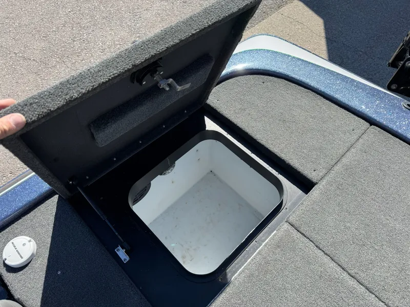 Slide: The Image of Open storage compartment on a 2019 Skeeter ZX225 boat. - 26