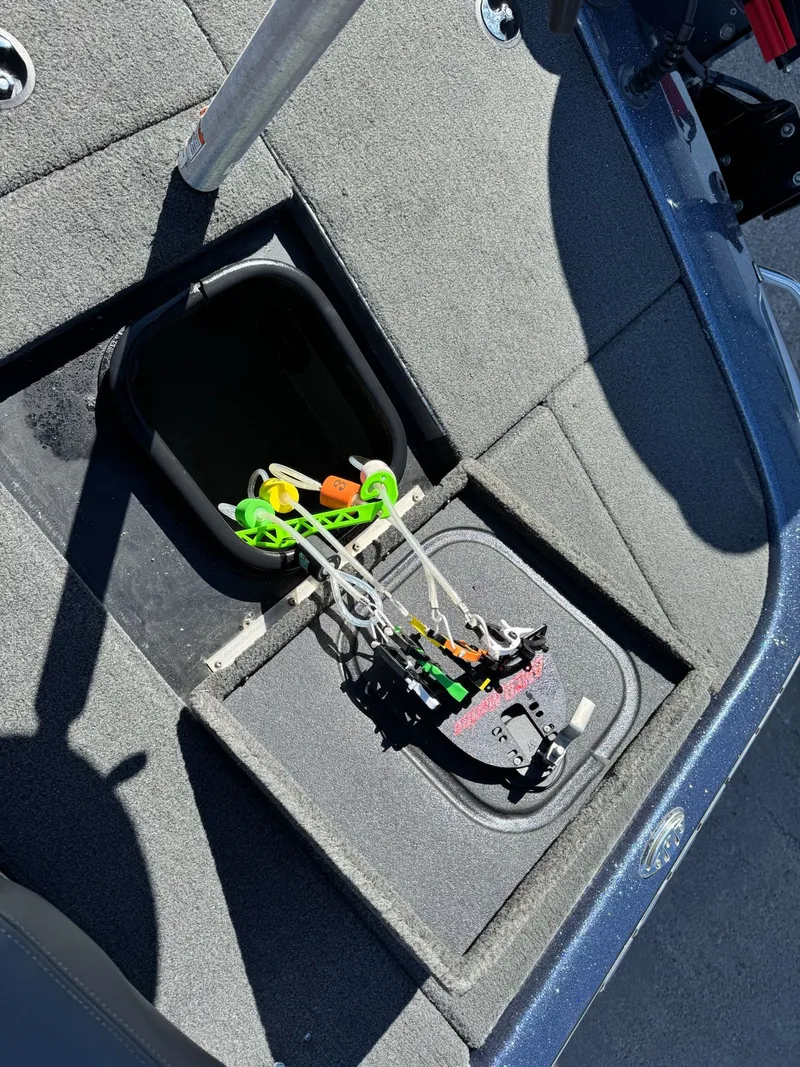 Slide: The Image of 2019 Skeeter ZX225 boat with open storage compartment and cables. - 30