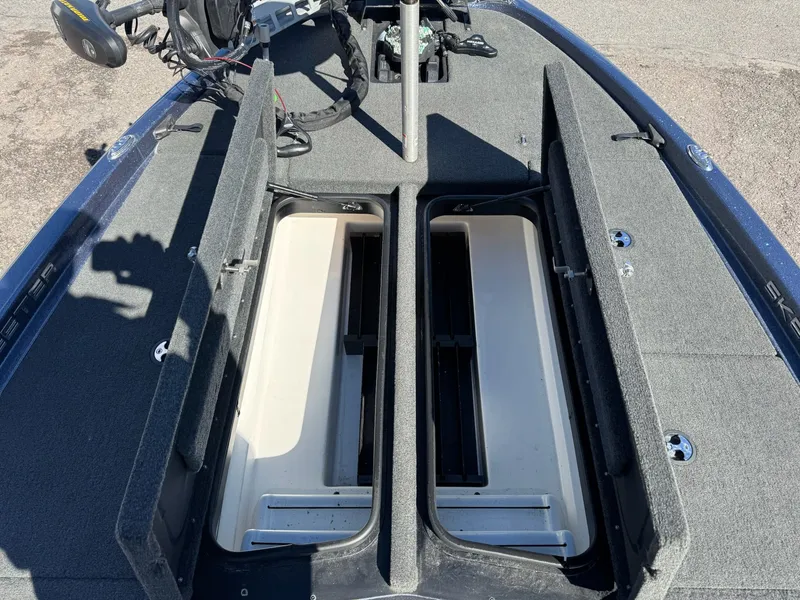 Slide: The Image of 2019 Skeeter ZX225 boat with open storage compartments. - 8