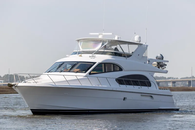 The Image of 2008 Hatteras 64 Motor Yacht cruising on calm waters, showcasing sleek design and luxury features. - 0