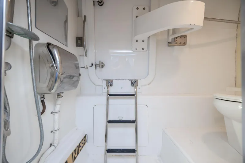 Slide: The Image of Interior of 2008 Hatteras 64 Motor Yacht bathroom with ladder and fixtures. - 104