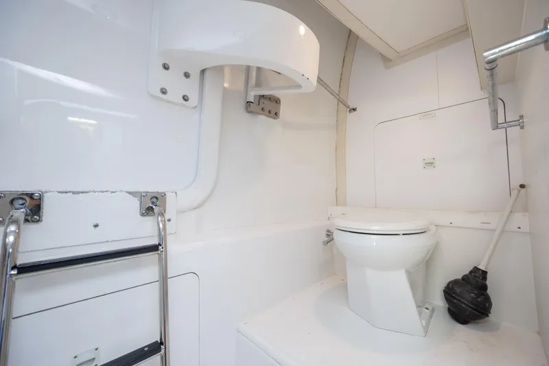 Slide: The Image of Bathroom interior of 2008 Hatteras 64 Motor Yacht, featuring a toilet and ladder. - 105