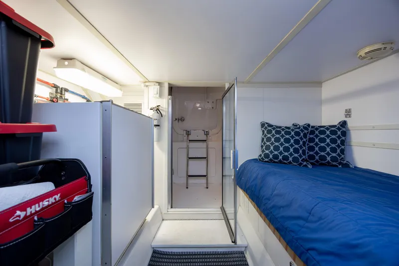 Slide: The Image of Interior of 2008 Hatteras 64 Motor Yacht with bed and storage area. - 109