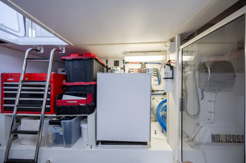 Slide: The Image of Engine room of 2008 Hatteras 64 Motor Yacht with tools and equipment storage. - 110