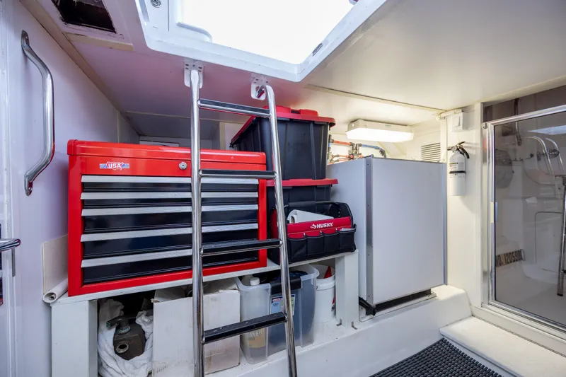 Slide: The Image of Engine room of 2008 Hatteras 64 Motor Yacht with tool storage and ladder access. - 111