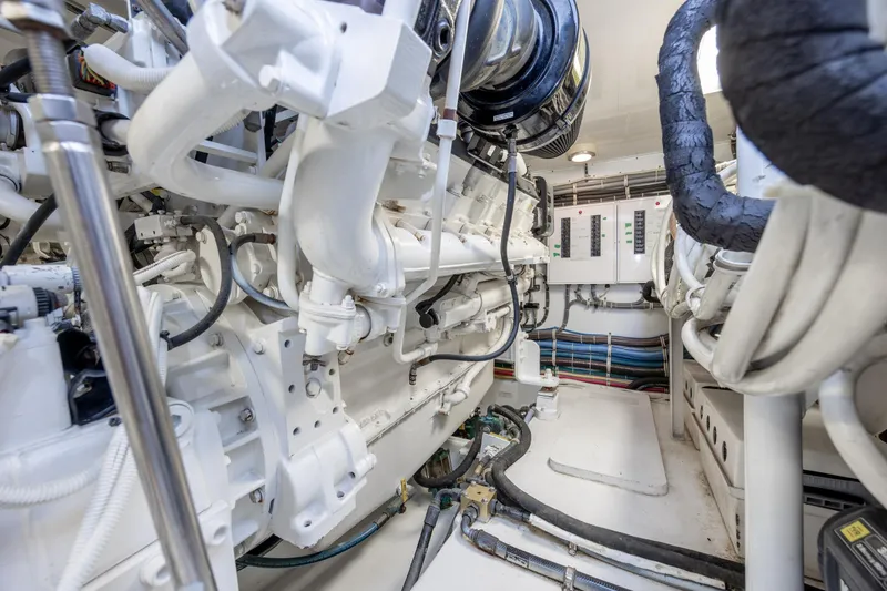 Slide: The Image of Engine room of a 2008 Hatteras 64 Motor Yacht, showcasing machinery and control panels. - 116