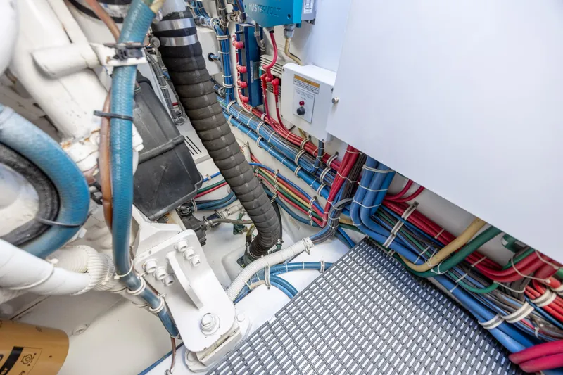 Slide: The Image of Engine room of 2008 Hatteras 64 Motor Yacht with organized wiring and hoses. - 117