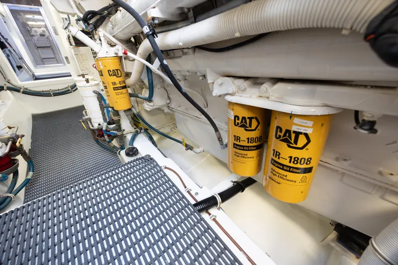 Slide: The Image of Engine room of 2008 Hatteras 64 Motor Yacht with CAT oil filters visible. - 122