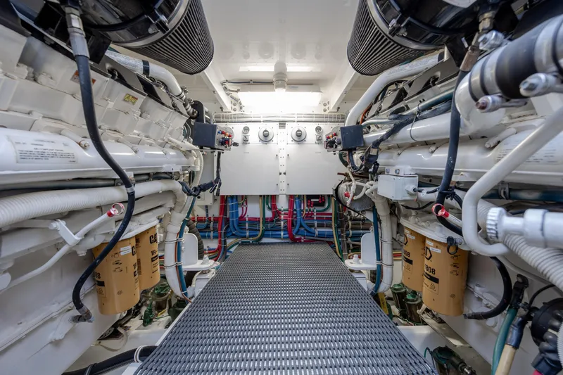 Slide: The Image of Engine room of 2008 Hatteras 64 Motor Yacht, showcasing dual engines and mechanical systems. - 129