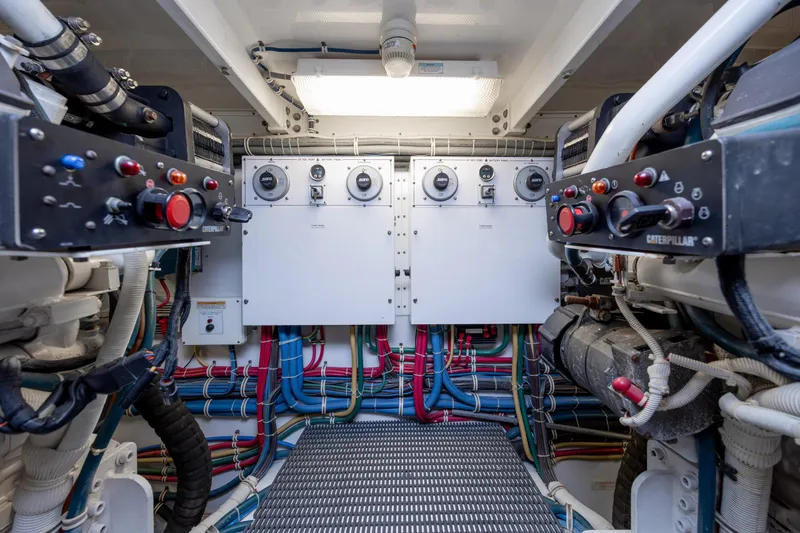 Slide: The Image of Engine room of 2008 Hatteras 64 Motor Yacht with control panels and wiring. - 130