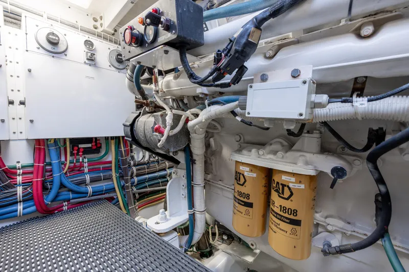 Slide: The Image of Engine room of 2008 Hatteras 64 Motor Yacht with wiring and filters visible. - 131