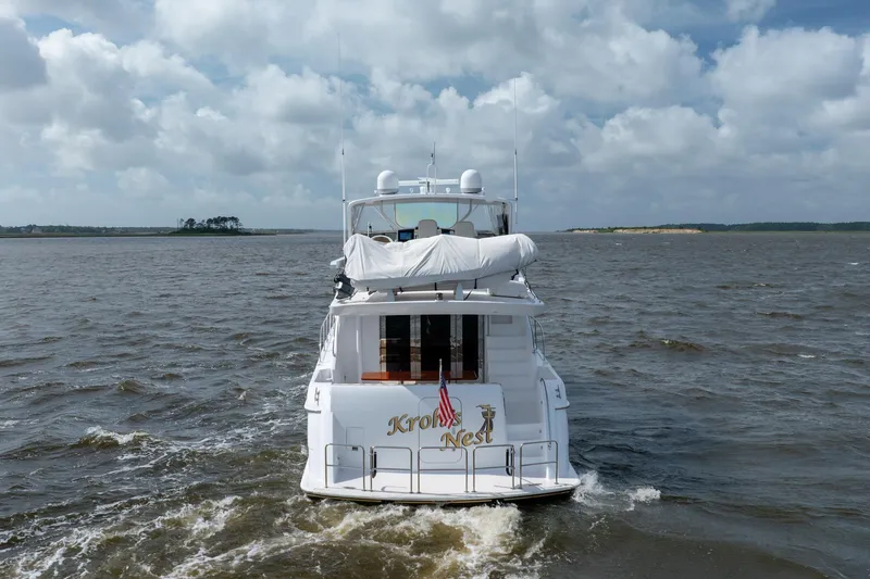 Slide: The Image of 2008 Hatteras 64 Motor Yacht cruising on open water under cloudy skies. - 15