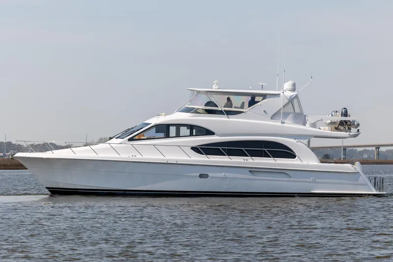 Slide: The Image of 2008 Hatteras 64 Motor Yacht cruising on calm waters, side view. - 2