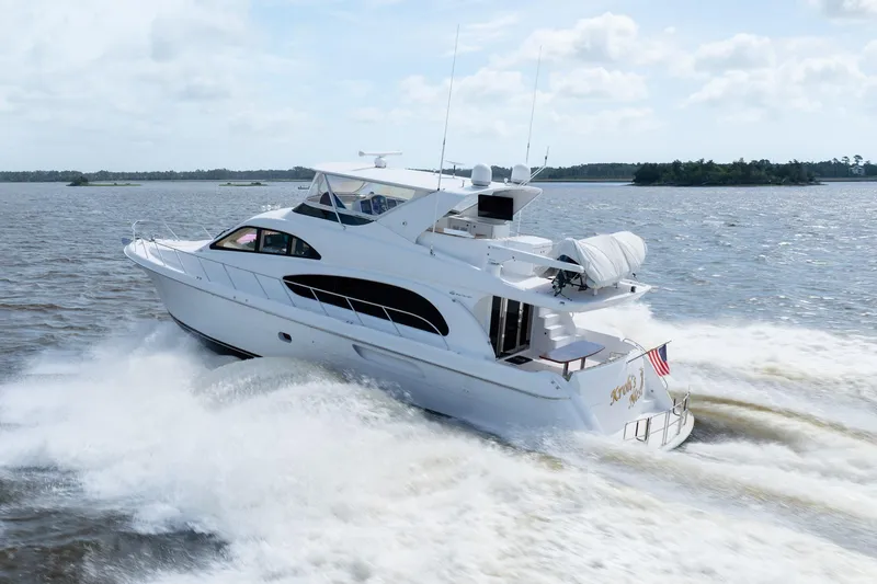 Slide: The Image of 2008 Hatteras 64 Motor Yacht cruising on open water, showcasing sleek design and powerful performance. - 23