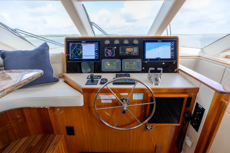 Slide: The Image of Helm of 2008 Hatteras 64 Motor Yacht with navigation screens and steering wheel. - 28