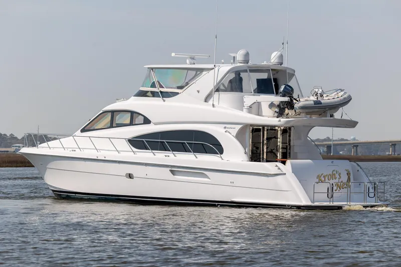Slide: The Image of 2008 Hatteras 64 Motor Yacht cruising on calm waters, showcasing sleek design and luxury features. - 3