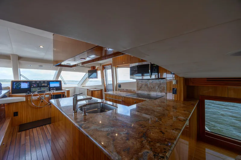 Slide: The Image of Luxurious interior of 2008 Hatteras 64 Motor Yacht with modern kitchen and helm. - 36