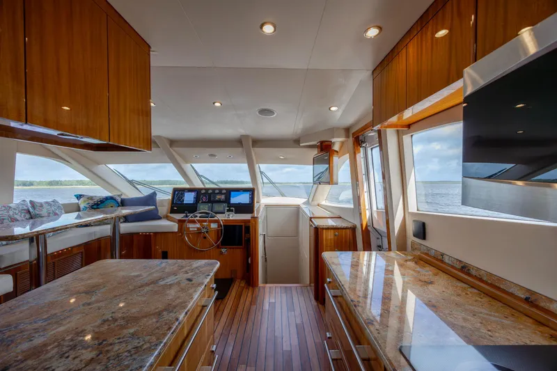 Slide: The Image of Luxurious interior of 2008 Hatteras 64 Motor Yacht with polished wood and modern helm. - 39