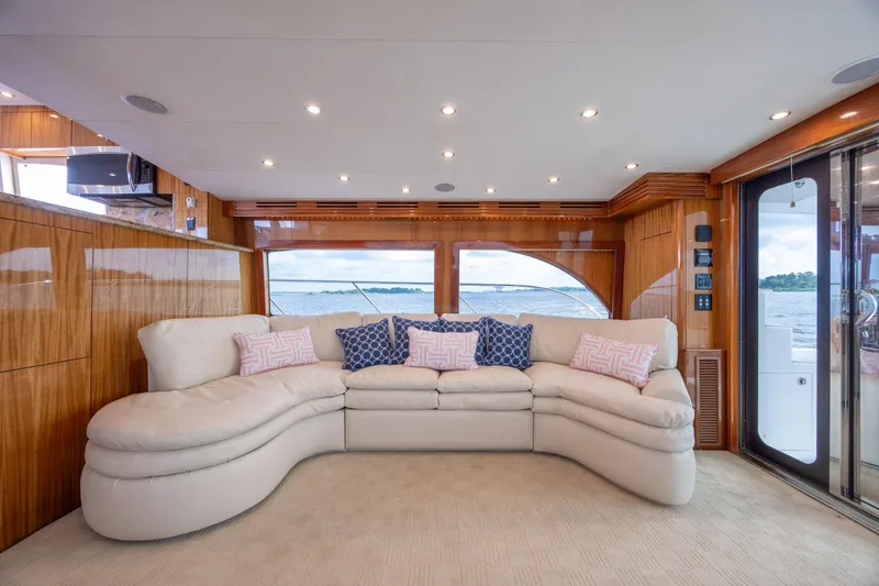Slide: The Image of Luxurious interior of 2008 Hatteras 64 Motor Yacht with plush seating and scenic window view. - 42