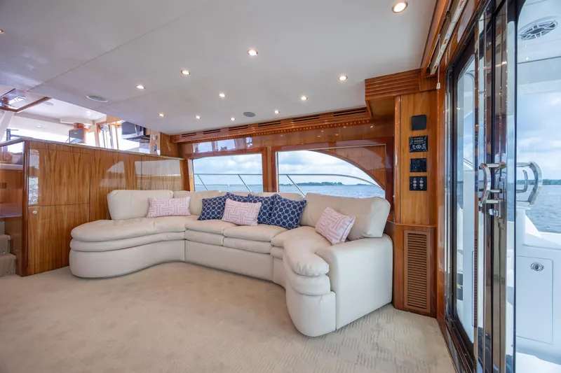 Slide: The Image of Luxurious interior of 2008 Hatteras 64 Motor Yacht with plush seating and elegant wood finishes. - 43