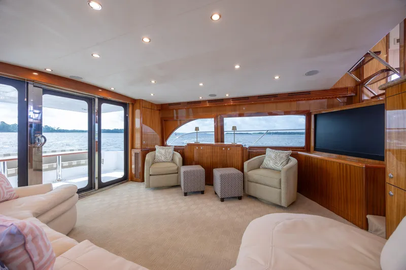Slide: The Image of Luxurious interior of 2008 Hatteras 64 Motor Yacht with elegant seating and panoramic windows. - 45
