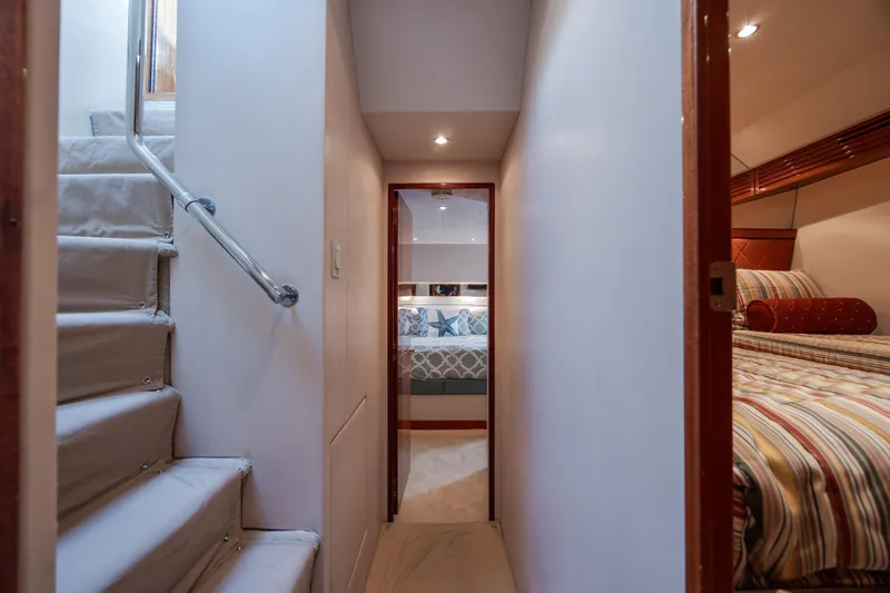 Slide: The Image of Interior hallway of 2008 Hatteras 64 Motor Yacht, featuring stairs and cozy bedrooms. - 49