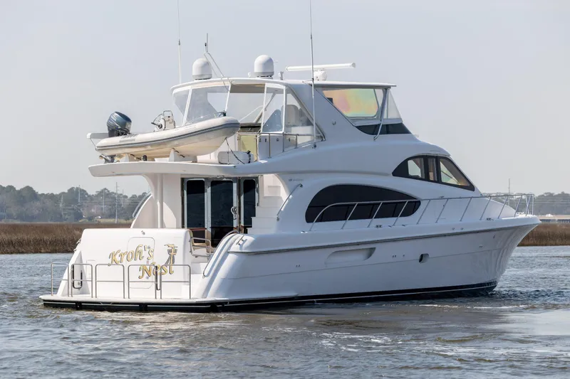 Slide: The Image of 2008 Hatteras 64 Motor Yacht cruising on calm waters, rear view. - 5