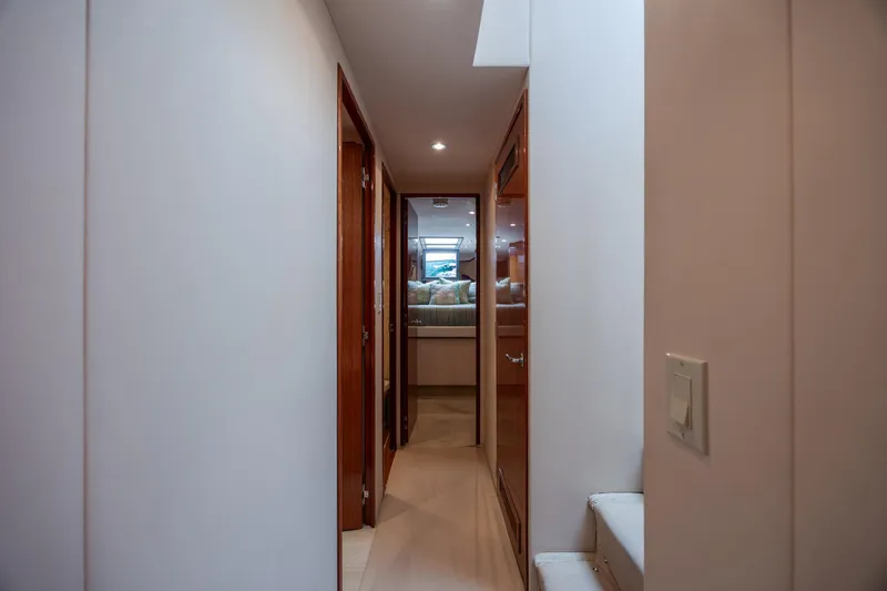 Slide: The Image of Hallway inside 2008 Hatteras 64 Motor Yacht, leading to a cozy bedroom. - 57