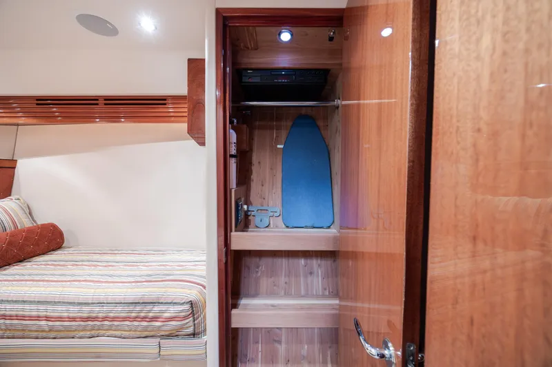 Slide: The Image of Luxurious 2008 Hatteras 64 Motor Yacht cabin with closet and ironing board. - 58