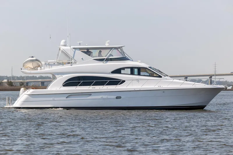 Slide: The Image of 2008 Hatteras 64 Motor Yacht cruising on calm waters. - 6
