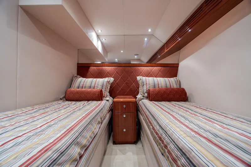 Slide: The Image of Luxurious twin cabin in 2008 Hatteras 64 Motor Yacht with striped bedding. - 61
