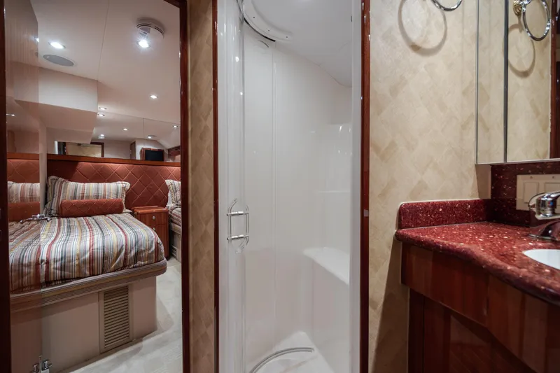 Slide: The Image of Luxurious 2008 Hatteras 64 Motor Yacht interior with bedroom and bathroom. - 65