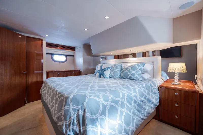 Slide: The Image of Luxurious bedroom interior of 2008 Hatteras 64 Motor Yacht with elegant bedding and wooden furnishings. - 68