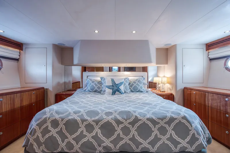 Slide: The Image of Luxurious bedroom interior of 2008 Hatteras 64 Motor Yacht with elegant bedding and wood cabinetry. - 69