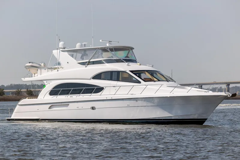 Slide: The Image of 2008 Hatteras 64 Motor Yacht cruising on calm waters. - 7