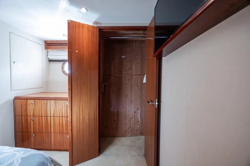 Slide: The Image of Interior of 2008 Hatteras 64 Motor Yacht with wooden cabinetry and open door. - 74