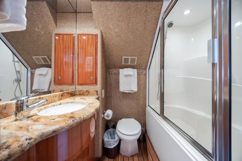 Slide: The Image of Luxurious bathroom in 2008 Hatteras 64 Motor Yacht with granite countertop and glass shower. - 76